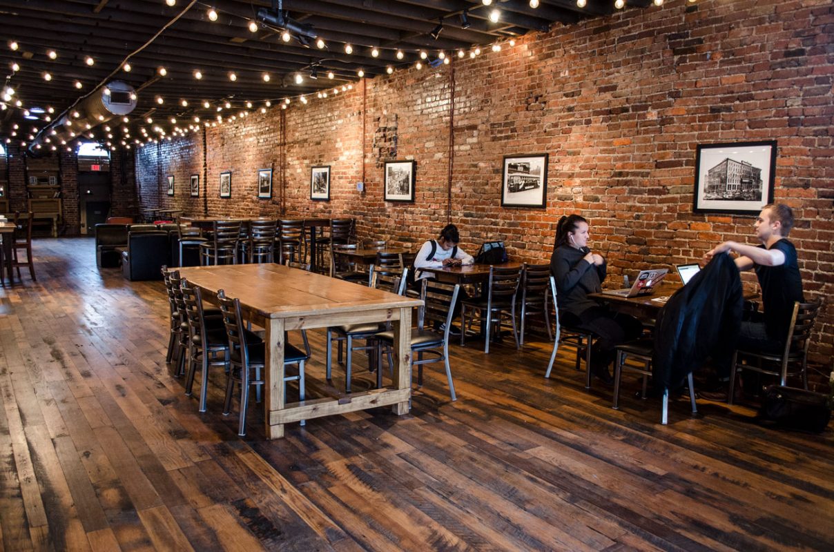 Downtown cafe seating area with people using WiFi and drinking coffee - Tin Cup Coffee Company Nashville, TN
