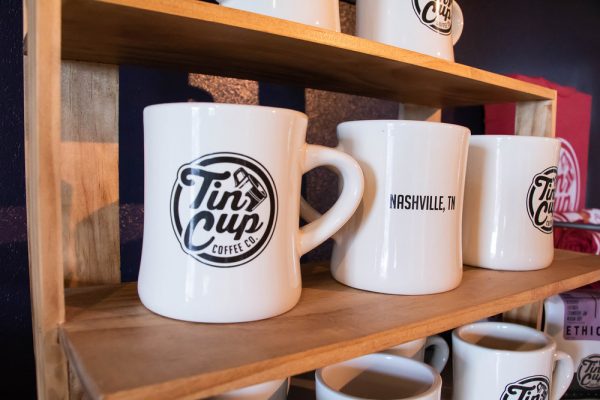 Ceramic coffee mugs on a shelf for sale - Tin Cup Coffee Company Nashville, TN